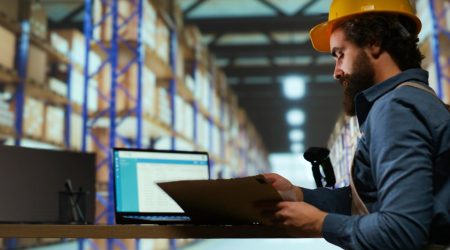 A beard man is looking at automation in retail warehouse